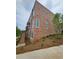Brick townhouse with a private entrance and lush, manicured landscaping at 401 Burton Dr, Alpharetta, GA 30009