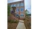 Brick townhouse with a private entrance, black railings, and professional landscaping at 401 Burton Dr, Alpharetta, GA 30009