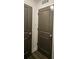 Hallway featuring two grey doors, white trim, and a return air vent in the ceiling at 401 Burton Dr, Alpharetta, GA 30009
