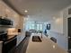 Modern kitchen with stainless appliances and island overlooks living space at 401 Burton Dr, Alpharetta, GA 30009