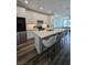 Modern kitchen featuring an island with seating, stainless steel appliances and white cabinetry at 401 Burton Dr, Alpharetta, GA 30009