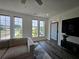 Bright living room features hardwood floors, multiple windows, and a comfortable couch at 401 Burton Dr, Alpharetta, GA 30009