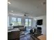 Bright living room features modern ceiling fan, hardwood floors, and large sunny windows at 401 Burton Dr, Alpharetta, GA 30009