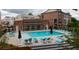 View of the community pool with ample seating and a modern clubhouse in the background at 401 Burton Dr, Alpharetta, GA 30009