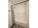 Bright shower tub with white subway tile, a dark shower rod, and a patterned shower curtain at 401 Burton Dr, Alpharetta, GA 30009