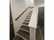 This staircase features wooden handrails and luxury vinyl plank flooring at 401 Burton Dr, Alpharetta, GA 30009