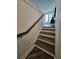 Well-lit staircase featuring wooden handrails and luxury vinyl plank flooring at 401 Burton Dr, Alpharetta, GA 30009