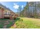 A view of the backyard with a deck, stairs, and grass lawn, great for outdoor enjoyment at 5826 Little Mountain Dr, Ellenwood, GA 30294