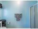 Bathroom with a shower featuring a glass door, a towel rack, and a toilet with a basket at 5826 Little Mountain Dr, Ellenwood, GA 30294