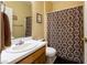 Bathroom with a vanity and toilet, featuring a shower with a patterned curtain at 5826 Little Mountain Dr, Ellenwood, GA 30294