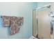 Clean bathroom featuring a shower with glass doors and towel rack at 5826 Little Mountain Dr, Ellenwood, GA 30294