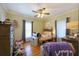 Cozy bedroom with a ceiling fan, hardwood floors, and ample storage space at 5826 Little Mountain Dr, Ellenwood, GA 30294