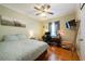 Well-lit bedroom with a ceiling fan, hardwood floors, and a functional workspace at 5826 Little Mountain Dr, Ellenwood, GA 30294