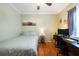 Comfortable bedroom features hardwood floors, a ceiling fan, and a cozy workspace at 5826 Little Mountain Dr, Ellenwood, GA 30294