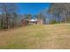 Sprawling front yard showcases a brick home with a cozy front porch and ample space at 5826 Little Mountain Dr, Ellenwood, GA 30294