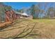 Brick home with a sloping front yard, showcasing a covered porch and classic architectural details at 5826 Little Mountain Dr, Ellenwood, GA 30294