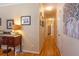 Long hallway enhanced with wood floors and neutral walls, providing a bright and welcoming atmosphere at 5826 Little Mountain Dr, Ellenwood, GA 30294