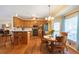 Open kitchen with wood cabinets, stainless steel appliances, breakfast bar, and adjacent dining area with natural light at 5826 Little Mountain Dr, Ellenwood, GA 30294