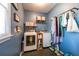 Efficient laundry room with washer, dryer, shelving and window creating a functional and bright space at 5826 Little Mountain Dr, Ellenwood, GA 30294