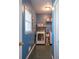 Efficient laundry room with washer, dryer, shelving and window creating a functional and bright space at 5826 Little Mountain Dr, Ellenwood, GA 30294