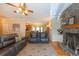 Comfortable living room with a stone fireplace and plush seating, complemented by warm lighting and hardwood flooring at 5826 Little Mountain Dr, Ellenwood, GA 30294