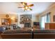 Inviting living room featuring hardwood floors, a stone fireplace, and comfortable leather sofas at 5826 Little Mountain Dr, Ellenwood, GA 30294