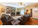 Cozy living room featuring a stone fireplace, comfortable leather seating, and welcoming decor at 5826 Little Mountain Dr, Ellenwood, GA 30294