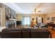 Warm living room features a stone fireplace, comfortable leather seating, and a welcoming front entrance at 5826 Little Mountain Dr, Ellenwood, GA 30294