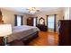 Spacious main bedroom with ceiling fan, hardwood floors, and natural light creating a comfortable retreat at 5826 Little Mountain Dr, Ellenwood, GA 30294