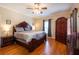 Serene main bedroom featuring a plush bed, hardwood floors, and elegant furniture for a relaxing ambiance at 5826 Little Mountain Dr, Ellenwood, GA 30294