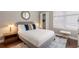 Cozy bedroom with natural light, a queen-sized bed, stylish furnishings, and hardwood floors at 893 Piedmont Ne Ave # 3, Atlanta, GA 30309