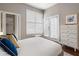 Bedroom featuring a white quilted bed, large windows, closet, and white chest of drawers at 893 Piedmont Ne Ave # 3, Atlanta, GA 30309