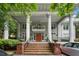 Grand home featuring a welcoming front porch with prominent columns, steps, and a balcony above the red front door at 893 Piedmont Ne Ave # 3, Atlanta, GA 30309