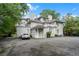 Rear exterior view of a multi-story home featuring balconies, an attached garage, and driveway parking at 893 Piedmont Ne Ave # 3, Atlanta, GA 30309