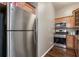 Galley kitchen featuring stainless steel appliances, wood cabinetry, and granite countertops at 893 Piedmont Ne Ave # 3, Atlanta, GA 30309