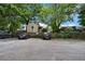 Image showcases ample parking behind a wooden fence, surrounded by lush trees at 893 Piedmont Ne Ave # 3, Atlanta, GA 30309