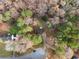 An aerial view shows this home surrounded by mature trees and other homes in the neighborhood at 247 Mandy Ct, Mcdonough, GA 30252