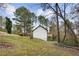 Back exterior of home with a wood deck overlooking a yard with lots of mature trees at 247 Mandy Ct, Mcdonough, GA 30252