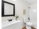 Bright bathroom featuring modern fixtures, a black framed mirror, and a shower-tub combo at 247 Mandy Ct, Mcdonough, GA 30252