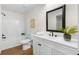 Clean bathroom with white cabinets, modern fixtures, and wood floors at 247 Mandy Ct, Mcdonough, GA 30252