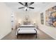 A cozy bedroom with natural light, neutral decor, and carpet floors with a bench at the foot of the bed at 247 Mandy Ct, Mcdonough, GA 30252
