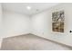 Bedroom with natural light streaming through the window and neutral carpet floors at 247 Mandy Ct, Mcdonough, GA 30252
