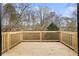 Spacious wood deck with wood railing and views of the surrounding trees at 247 Mandy Ct, Mcdonough, GA 30252