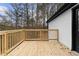 Wood deck attached to the exterior of the house with wood railing and views of the surrounding trees at 247 Mandy Ct, Mcdonough, GA 30252