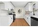 Modern kitchen with white cabinets, stainless steel appliances, and wood floors at 247 Mandy Ct, Mcdonough, GA 30252