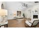 Living room featuring wood floors, a fireplace, and white neutral furniture at 247 Mandy Ct, Mcdonough, GA 30252