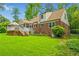 Expansive backyard with a deck, screened porch, and lush greenery at 3449 Parkview Dr, Atlanta, GA 30337