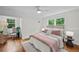 Bright bedroom with hardwood floors and a comfortable bed with a view of the yard at 3449 Parkview Dr, Atlanta, GA 30337