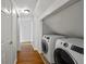 Convenient laundry area with modern machines and a hallway leading to other parts of the home at 3449 Parkview Dr, Atlanta, GA 30337
