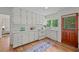 Bright kitchen with white cabinets, modern appliances, hardwood floors, and ample counter space at 3449 Parkview Dr, Atlanta, GA 30337